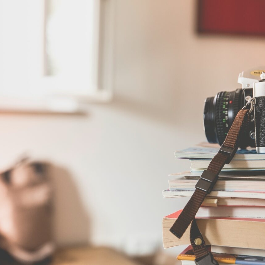 photo of a camera on top of a stack of books used for blog post social media trends 2019