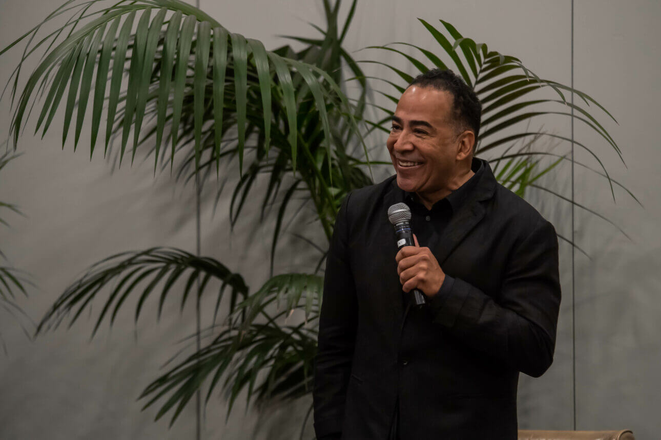 Tim storey smiling and holding a microphone